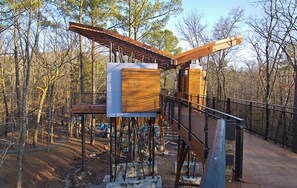 Under construction, this property features a wooden deck and metal railing.