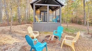 A cabin with a porch, four Adirondack chairs, and a fire pit. - Serene, Hiking, Dreamer at Mentone Free Internet! (Mentone)
