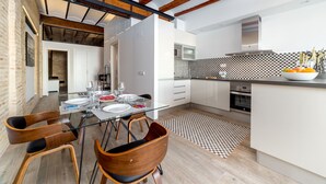 A modern kitchen with white cabinets, a black and white checkered backsplash, and a wooden ceiling. - CENTER-Luxurious 1BR, 1BA-Terrace, WI-FI, A/C (Valencia)