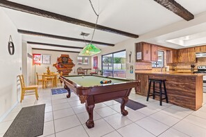 Enjoy a game of pool or dine with friends in this spacious room featuring a pool table and dining area.