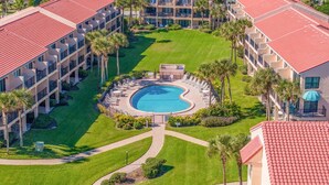 A resort with a central pool, multiple buildings with red-tiled roofs, and surrounding greenery. - NEW LISTING!!! DIRECT OCEAN FRONT 1st FLOOR SEA PLACE CONDO!!! 2bd/2 bath (St. Augustine)