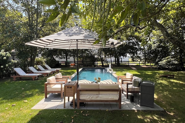 Heated outdoor pool with lounge chairs, plus sitting area w/ sofa and chairs