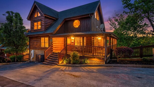 A log cabin with a porch, a staircase, and a satellite dish. - Lux Lodge! Pool-Sauna-HotTub-Game-Pet Frndly (Sevierville)