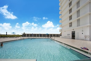 Relax by the pool with lounge chairs and umbrellas.