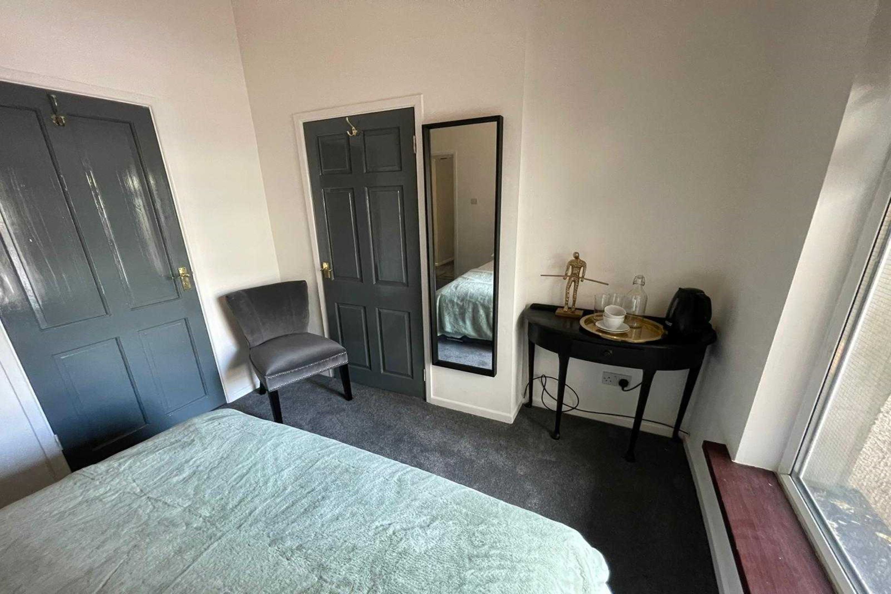 family room, multiple beds (family of 3) | iron/ironing board, bed sheets