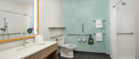 A modern bathroom with a white sink, a toilet, a shower, and a towel rack.