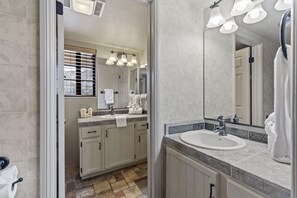 A modern bathroom with a large mirror, two sinks, and a window with blinds. - Interlaken 32 overlooking the lake and Sierra. (June Lake)