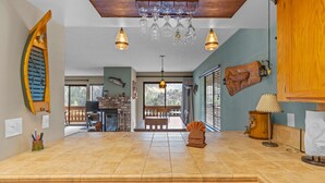 A kitchen with a wooden countertop, a dishwasher, and a hanging light fixture. - Interlaken 3, one bedroom getaway (June Lake)