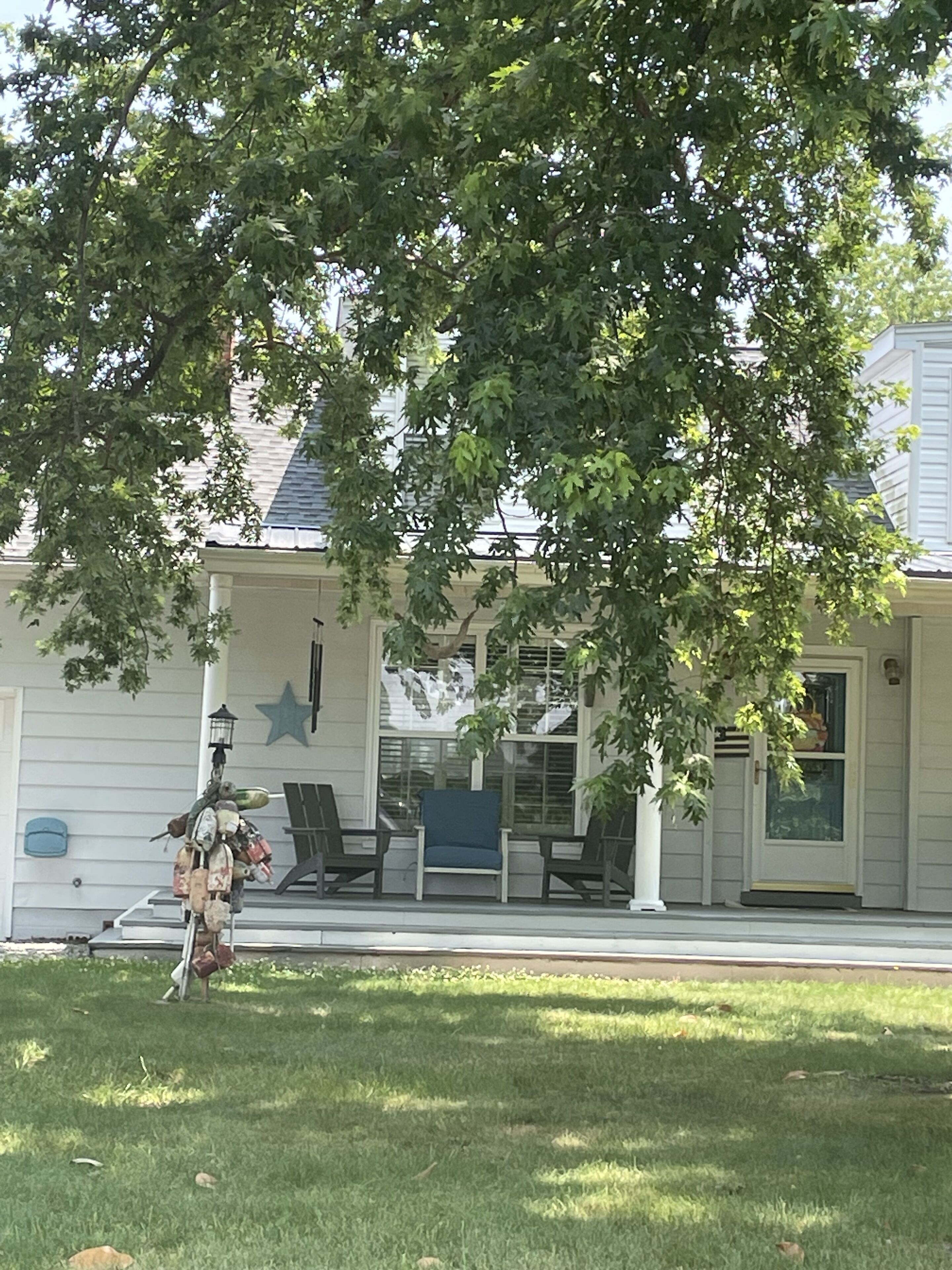 A house with a porch, a star decoration, and a chair.