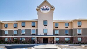 A Suburban Extended Stay Hotel with a central tower, multiple windows, and a parking lot with handicapped accessibility. - Suburban Studios Midland I-20 (Midland)