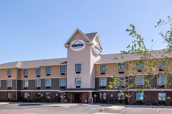 A Suburban Extended Stay Hotel with a central tower, multiple windows, and a brick facade. - Suburban Studios Midland I-20 (Midland)