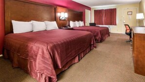 A hotel room with two beds, a desk, a chair, and a window with curtains. - Ramada Limited Gilroy (Gilroy)