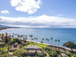 A coastal resort with a pool, palm trees, and a view of the ocean. - Ma'alaea Surf, D9 - Oceanfront Condo - remodeled two-bedroom, 2nd Floor (Kihei)