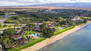 An aerial view of a coastal resort with a beach, pool, and solar panels on buildings. - Ma'alaea Surf, D9 - Oceanfront Condo - remodeled two-bedroom, 2nd Floor (Kihei)