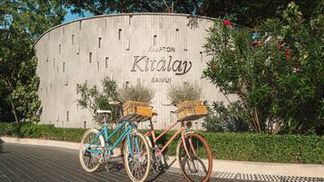 A building with a sign reading "KIMALAY SAMUI" and two bicycles parked in front.