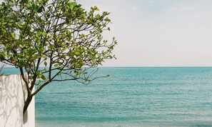 On the beach, white sand, sun loungers, beach umbrellas