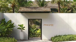 A modern building entrance with a sign reading "Kratavare Spa & Wellness". - Kimpton Kitalay Samui by IHG (Koh Samui)