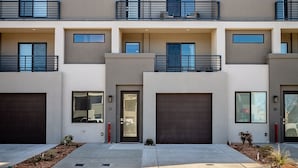 A modern multi-story residential building with a flat roof, large windows, and a clean, minimalist design. - Spacious and Affordable Townhome, 5 BD/4.5 BA at The Vue in St. George (St. George)