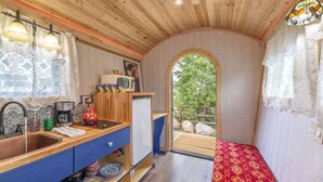 A compact kitchen with wooden cabinets, a sink, and a small refrigerator. - ☆ Magical Gypsy Wagon ☆ Unique Mountain Getaway (Fairplay)