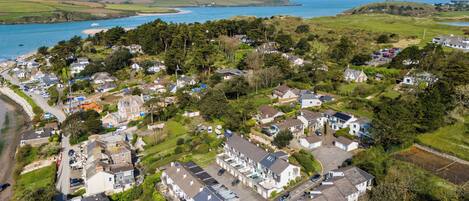 A coastal residential area with houses, roads, and a beach.