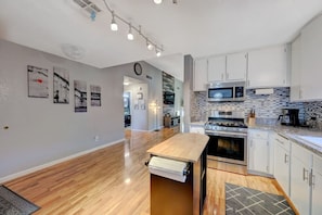 Enjoy cooking in this well-equipped kitchen with a central island, oven, and microwave.