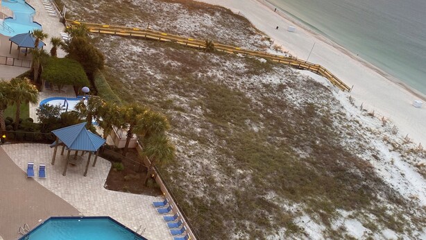 A resort with a swimming pool, beach access, and a sunset view. - Romantic One-bedroom Condo in Orange Beach - Beautiful Gulf-front Views. (Orange Beach)