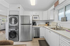 A compact kitchen with a washing machine, refrigerator, microwave, and sink. - 🏡 Cozy Family Cottage Retreat | Beach • BBQ • Fire Pit | Sleeps 5 (Innisfil)