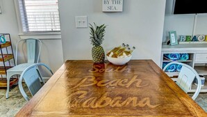 A wooden dining table with the words "South Beach, Panama" engraved on it. - South Beach Cabana Down | Patio | Pool | Across Street from Beach (Fernandina Beach)