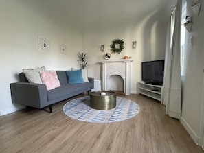 Relax in this stylish living room with a cozy fireplace, flat-screen TV, and comfortable seating area.