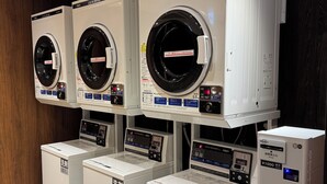 A row of stacked washing machines in a commercial setting. - APA Hotel Osaka Kadomashi Ekimae (Kadoma)