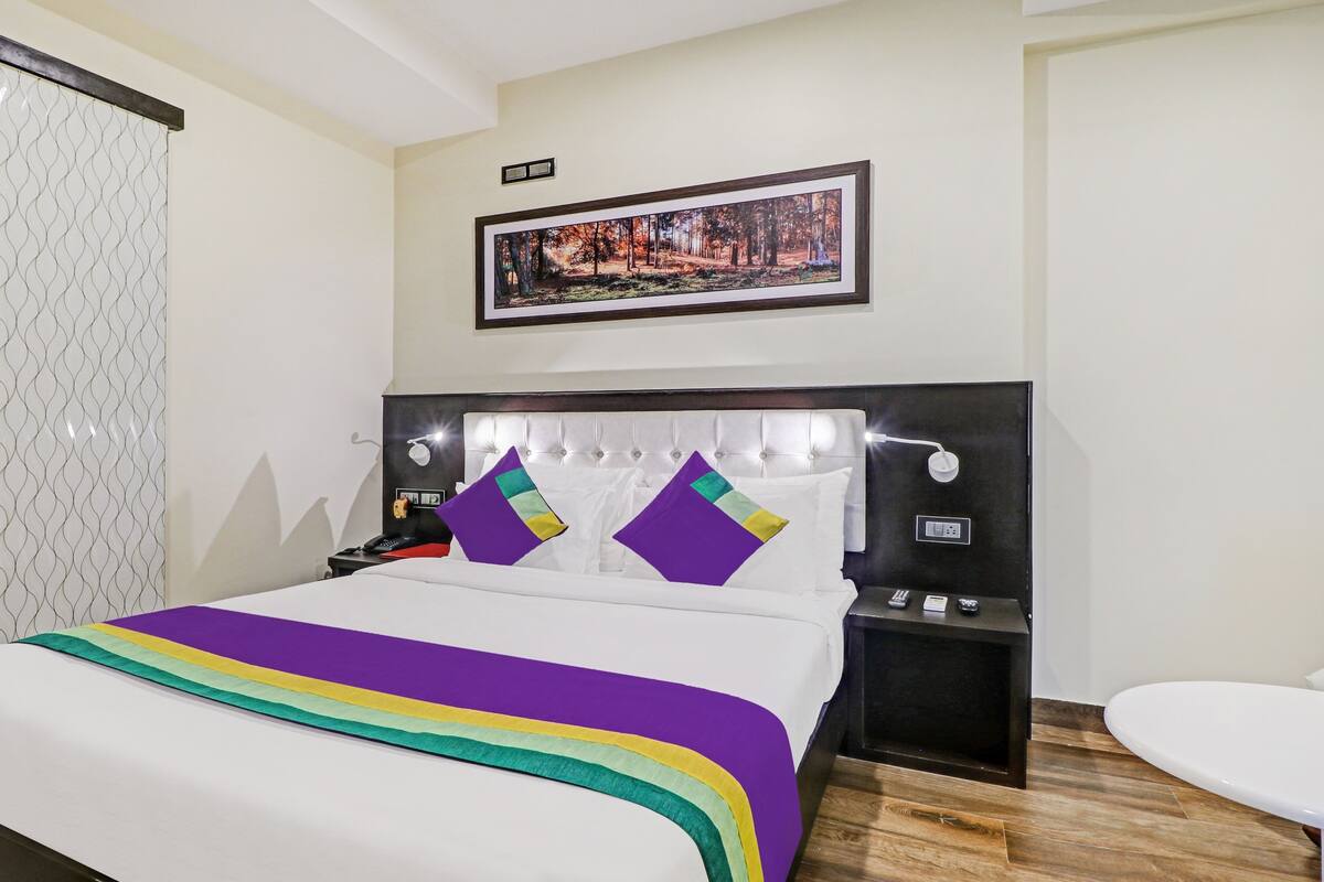 Desk, iron/ironing board, bed sheets