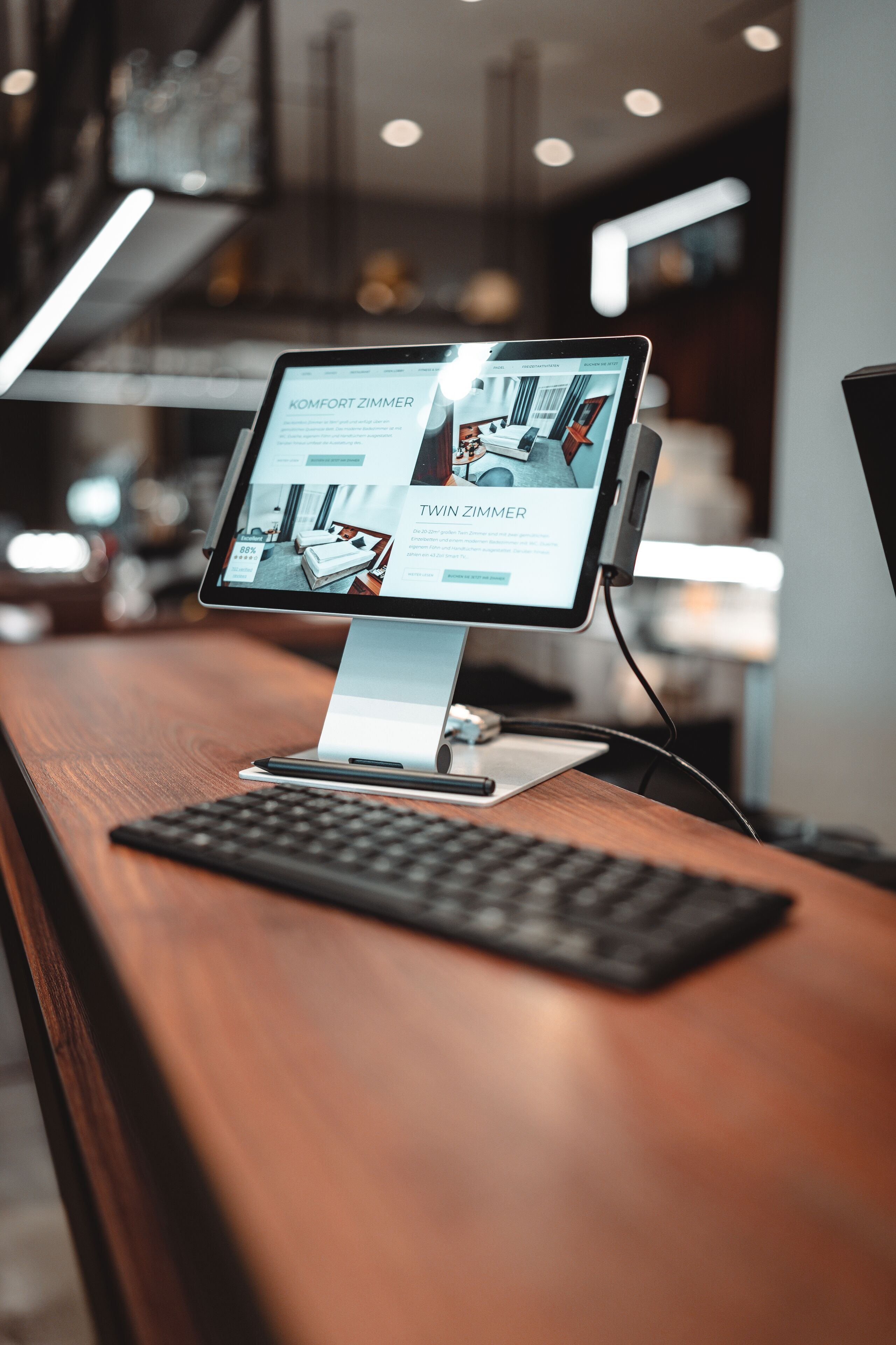 A desktop computer with a monitor displaying a website about a hotel room.