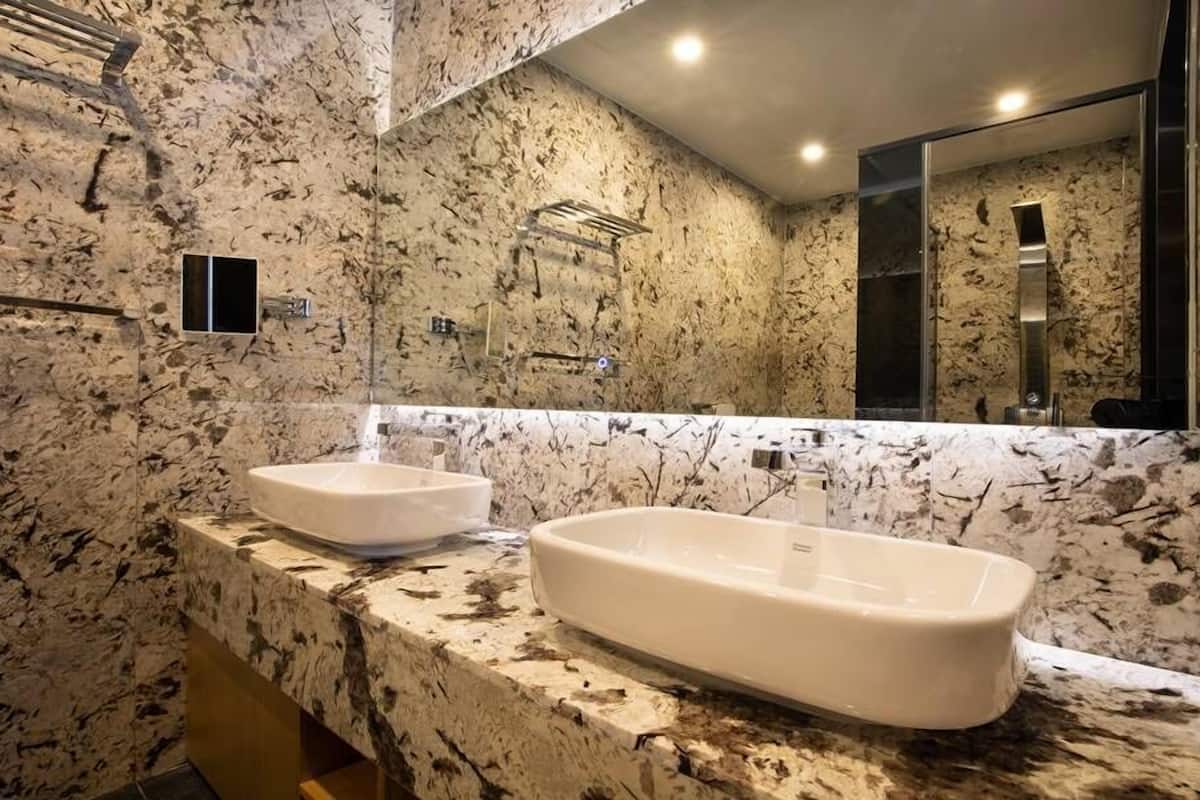 deluxe suite | bathroom | hair dryer, bathrobes, slippers, towels