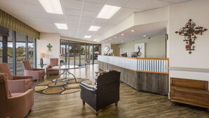 A spacious lobby with a reception desk, comfortable seating, and a large window offering a view of the outdoors. - Econo Lodge Vidalia (Vidalia)
