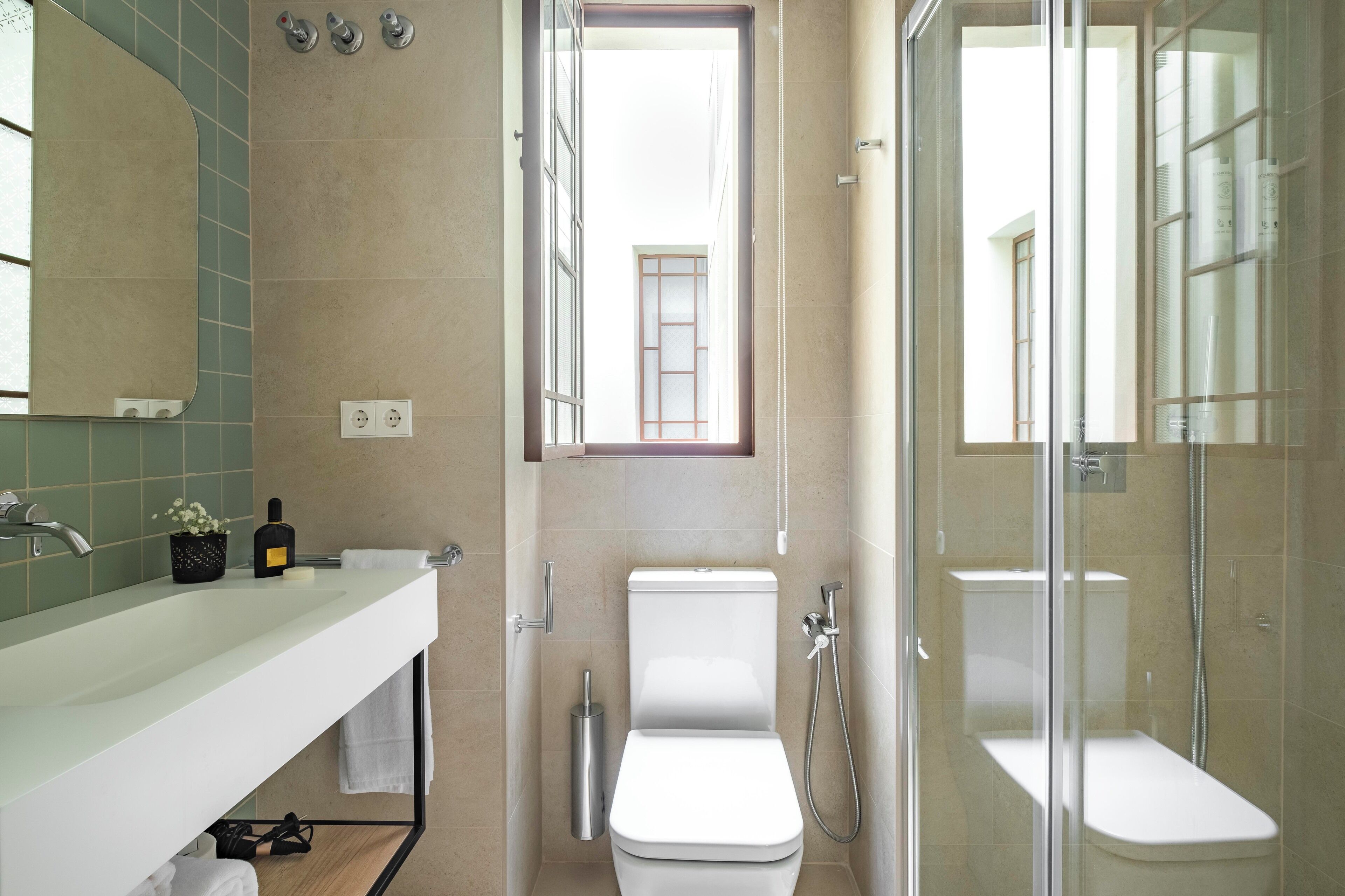 Un baño moderno con lavamanos grande, inodoro y ducha.