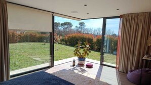 A bedroom with a large sliding glass door leading to a garden. - Modern air-conditioned villa, rated 4 stars+large heated swimming pool+beach volleyball court (Flayosc)