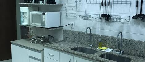 Microwave, coffee/tea maker, cookware/dishes/utensils, dining tables