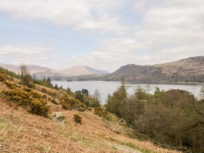 A natural landscape with a lake, hills, and sparse vegetation. - Derwent Haven (Keswick)