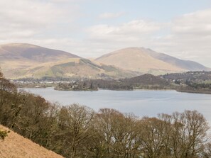 A lake surrounded by hills with a town in the distance. - Derwent Haven (Keswick)