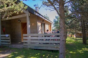 Cozy cabin with a covered porch, perfect for relaxation.