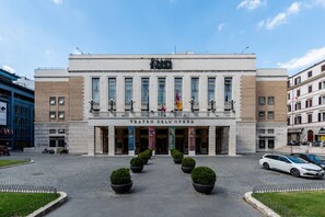 A large building with a sign reading 'Teatro dell'Opera' and a series of windows.