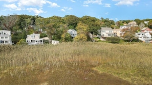 A residential area with houses, a grassy field, and trees. - Walk To Good Harbor, OCEAN VIEWS, Open All Year! (Gloucester)