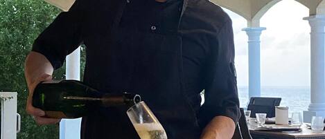A person pouring a drink into a glass.