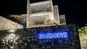 A modern building with a stone facade and a sign that reads "Beach House." - Modern 2-bed Sleeps 4 With Balcony (Grand-Baie)