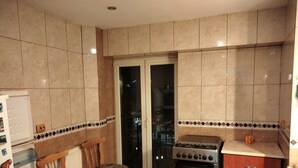 A kitchen with a stove, chairs, and a refrigerator. - Libertatii 22, old City, central (București)