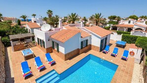 A pool area with blue lounge chairs and a swimming pool. - Villa Carianne by Villa Plus (Son Carrió)