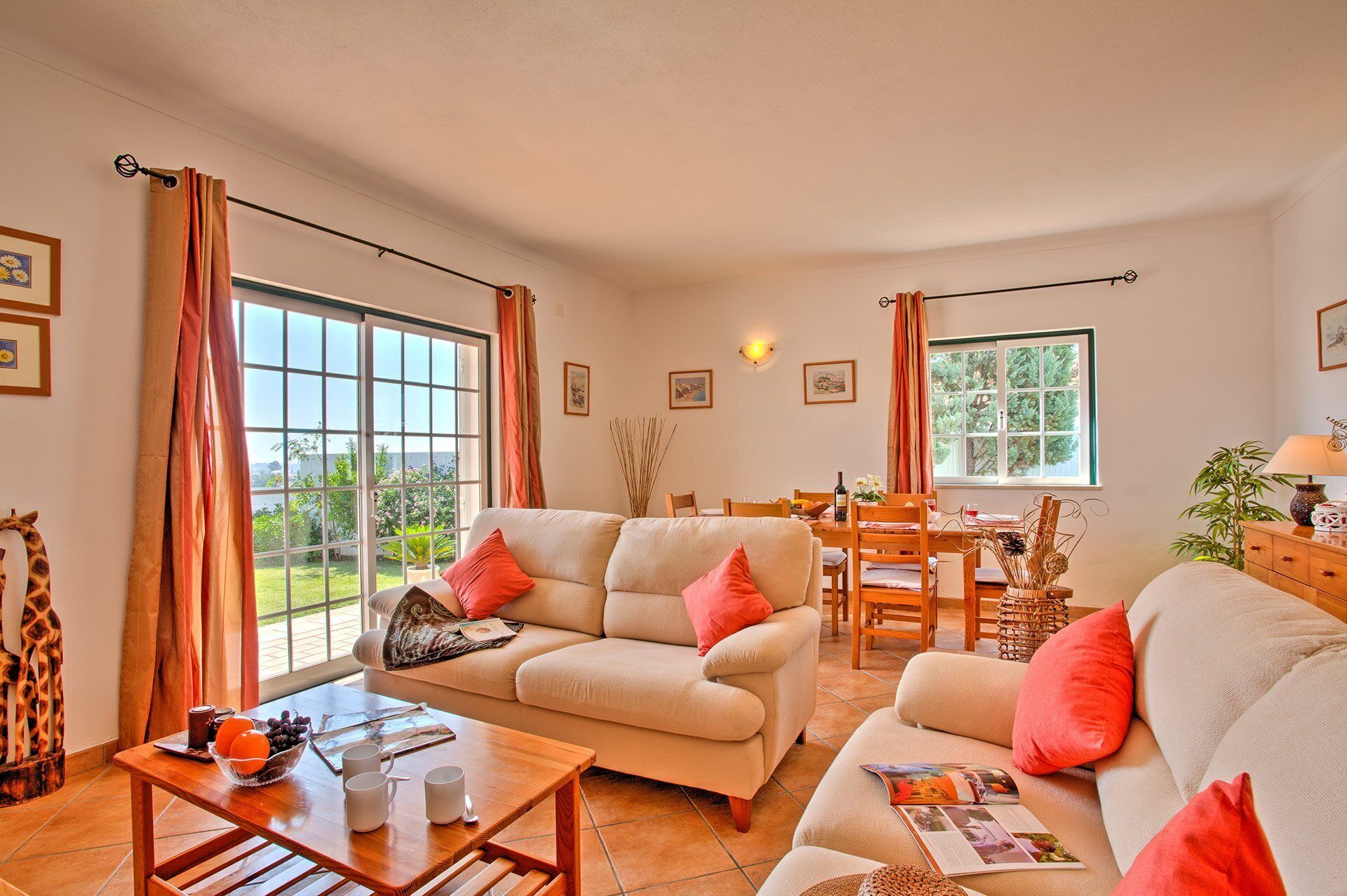 A cozy living room with two sofas, a coffee table, and a dining area with a table and chairs.