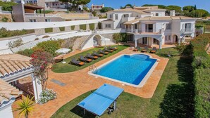 A large swimming pool with sun loungers, a ping pong table, and a well-maintained lawn. - Villa Tess by Villa Plus (Praia do Carvoeiro)