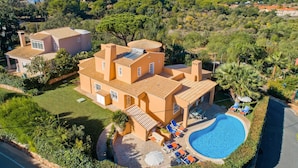 A large villa with a swimming pool, surrounded by lush greenery and a hilly landscape. - Villa Casa do Mel by Villa Plus (Loule)
