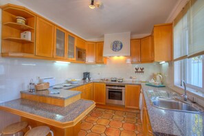 Enjoy cooking in this well-equipped kitchen with a central island, oven, and microwave.